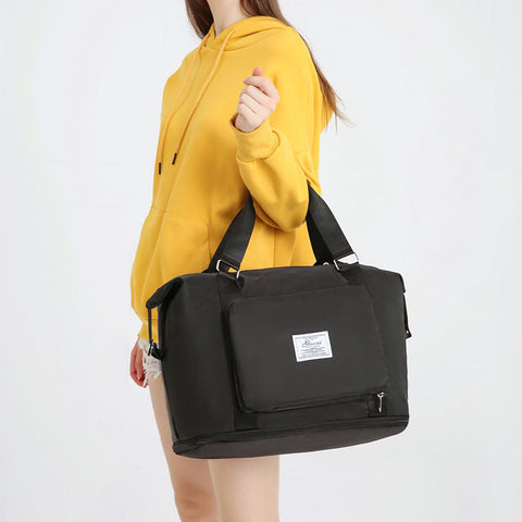 Black convertible backpack handbag carried by woman in yellow hoodie from CJ bags and shoes
