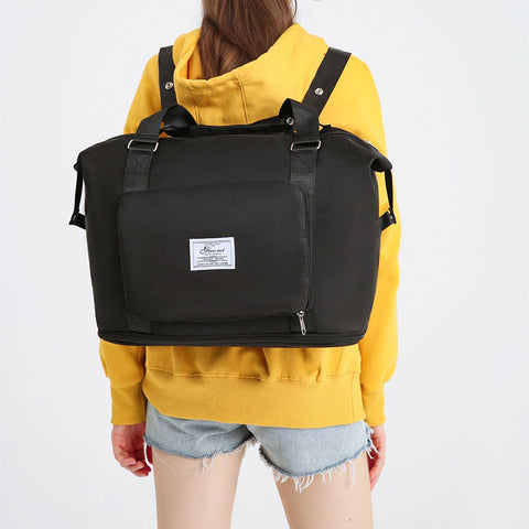 CJ black convertible backpack handbag worn by woman in yellow hoodie and denim shorts
