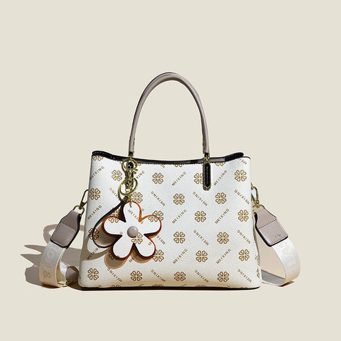 CJ floral pendant crossbody bag in white with brown flower charm and adjustable strap