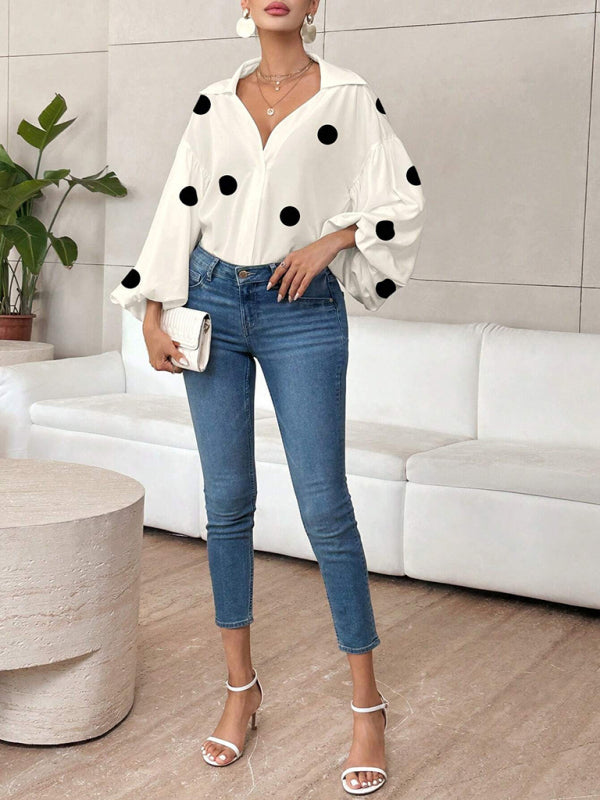 Polka dot, loose-fitting, puff-sleeved top with a semi-open collar.