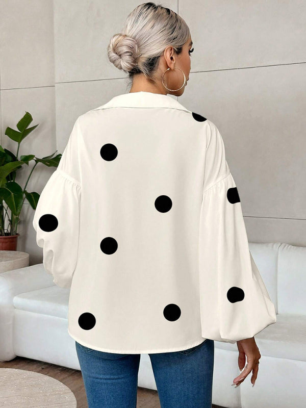 Polka dot, loose-fitting, puff-sleeved top with a semi-open collar.