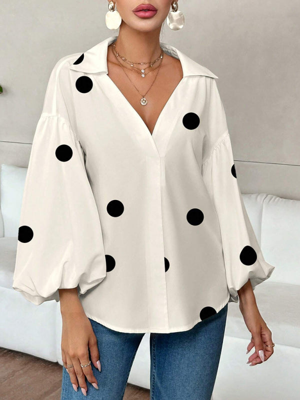 Polka dot, loose-fitting, puff-sleeved top with a semi-open collar.