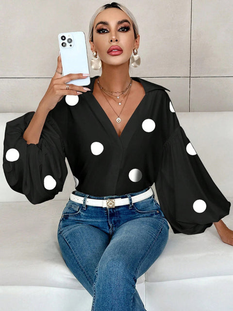 Polka dot, loose-fitting, puff-sleeved top with a semi-open collar.