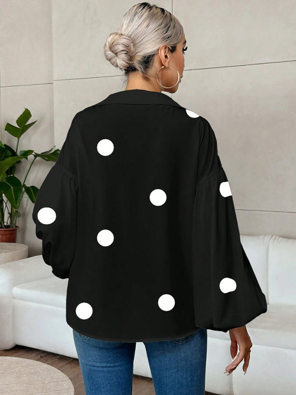 Polka dot, loose-fitting, puff-sleeved top with a semi-open collar.