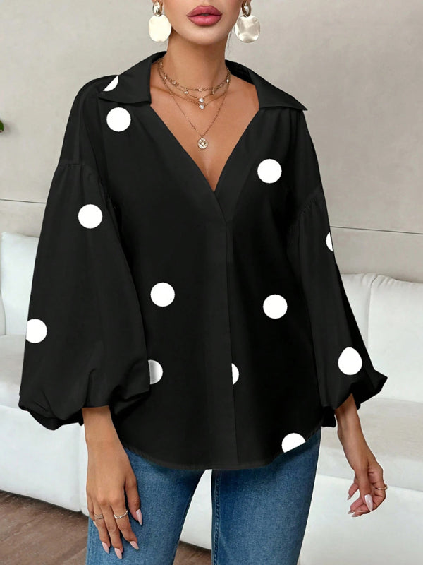 Polka dot, loose-fitting, puff-sleeved top with a semi-open collar.
