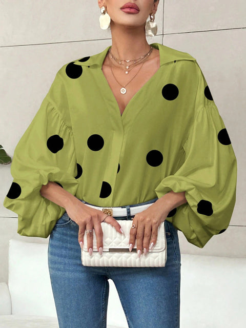 Polka dot, loose-fitting, puff-sleeved top with a semi-open collar.
