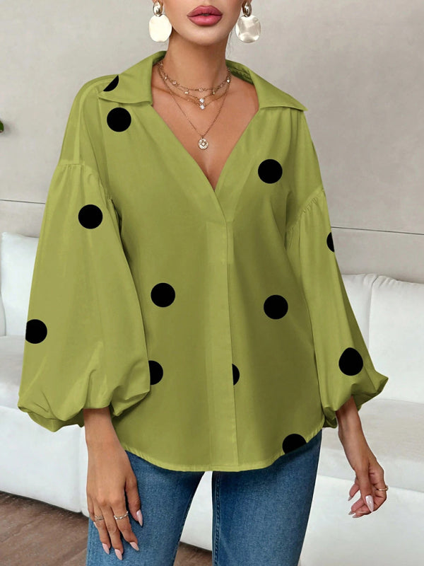 Polka dot, loose-fitting, puff-sleeved top with a semi-open collar.