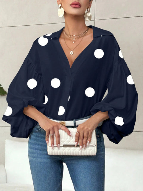 Polka dot, loose-fitting, puff-sleeved top with a semi-open collar.