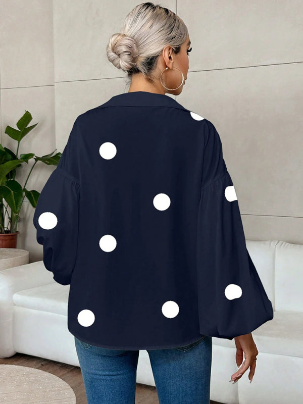Polka dot, loose-fitting, puff-sleeved top with a semi-open collar.