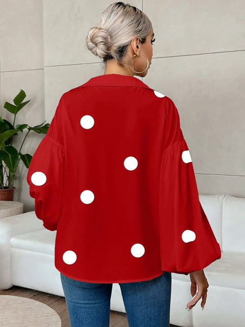 Polka dot, loose-fitting, puff-sleeved top with a semi-open collar.