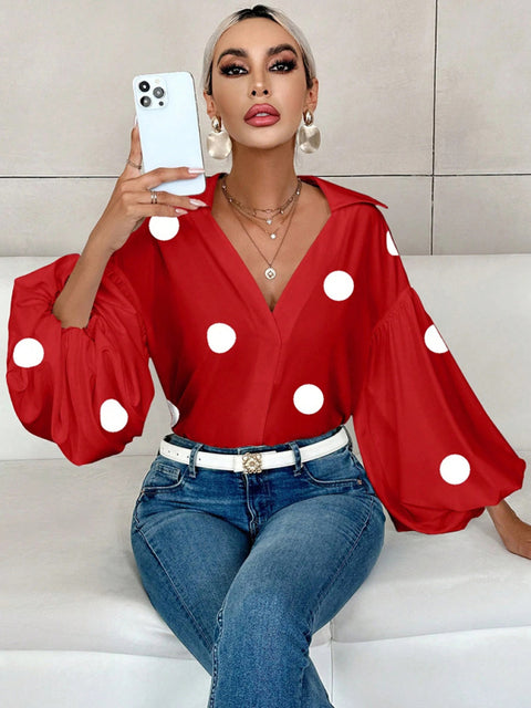 Polka dot, loose-fitting, puff-sleeved top with a semi-open collar.