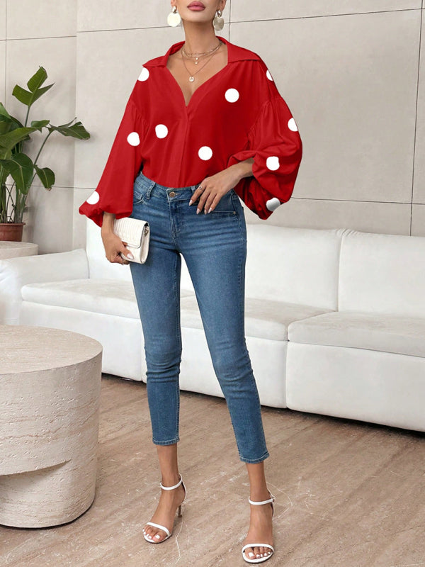 Polka dot, loose-fitting, puff-sleeved top with a semi-open collar.
