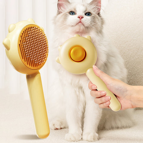 CJ pet hair removal brush in yellow held near a fluffy white cat for easy grooming