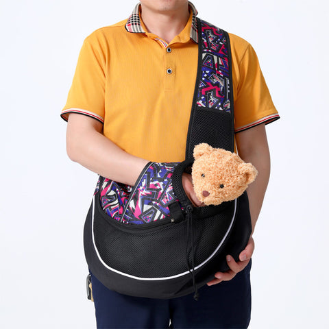 CJ portable pet carrier bag in black with colorful strap holding a small teddy bear