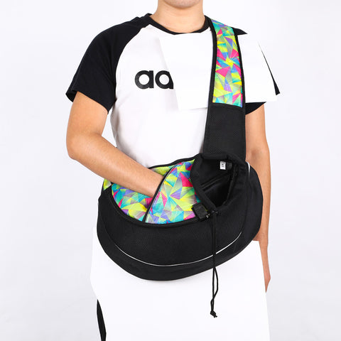 Colorful portable pet carrier bag worn by person for easy carrying and comfort on the shoulder