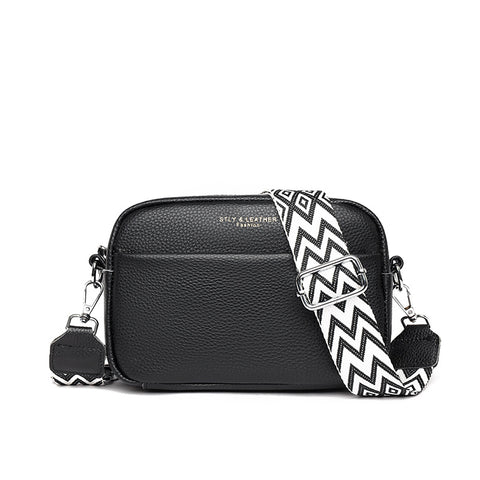 Black rhombus embroidered crossbody bag with a bold black and white zigzag strap by CJ