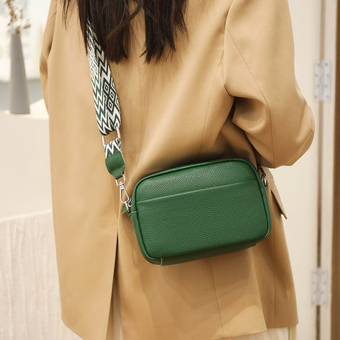 CJ green rhombus embroidered crossbody bag with adjustable patterned strap worn with beige jacket