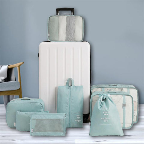 CJ 8-piece packing cube set in light blue with various sizes for organized travel and storage